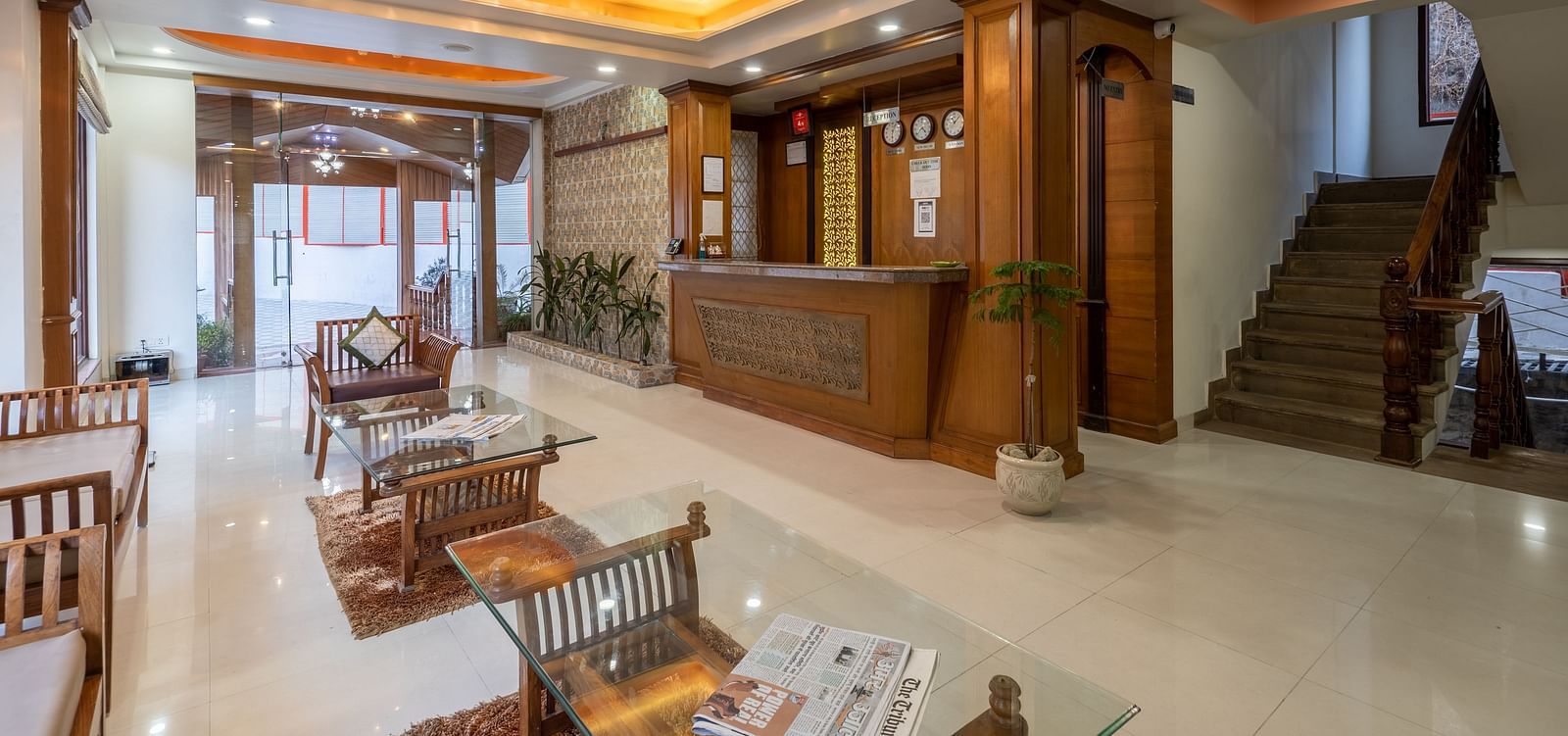 Lobby area with seating arrangements and a staircase leading upwards at DLS Hotels The Rock Castle.